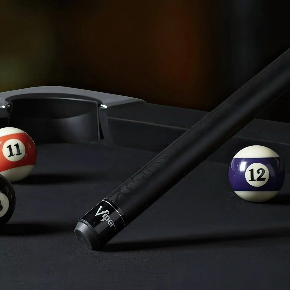Viper Black Unwrapped Billiard Pool Cue Stick on a billiard table